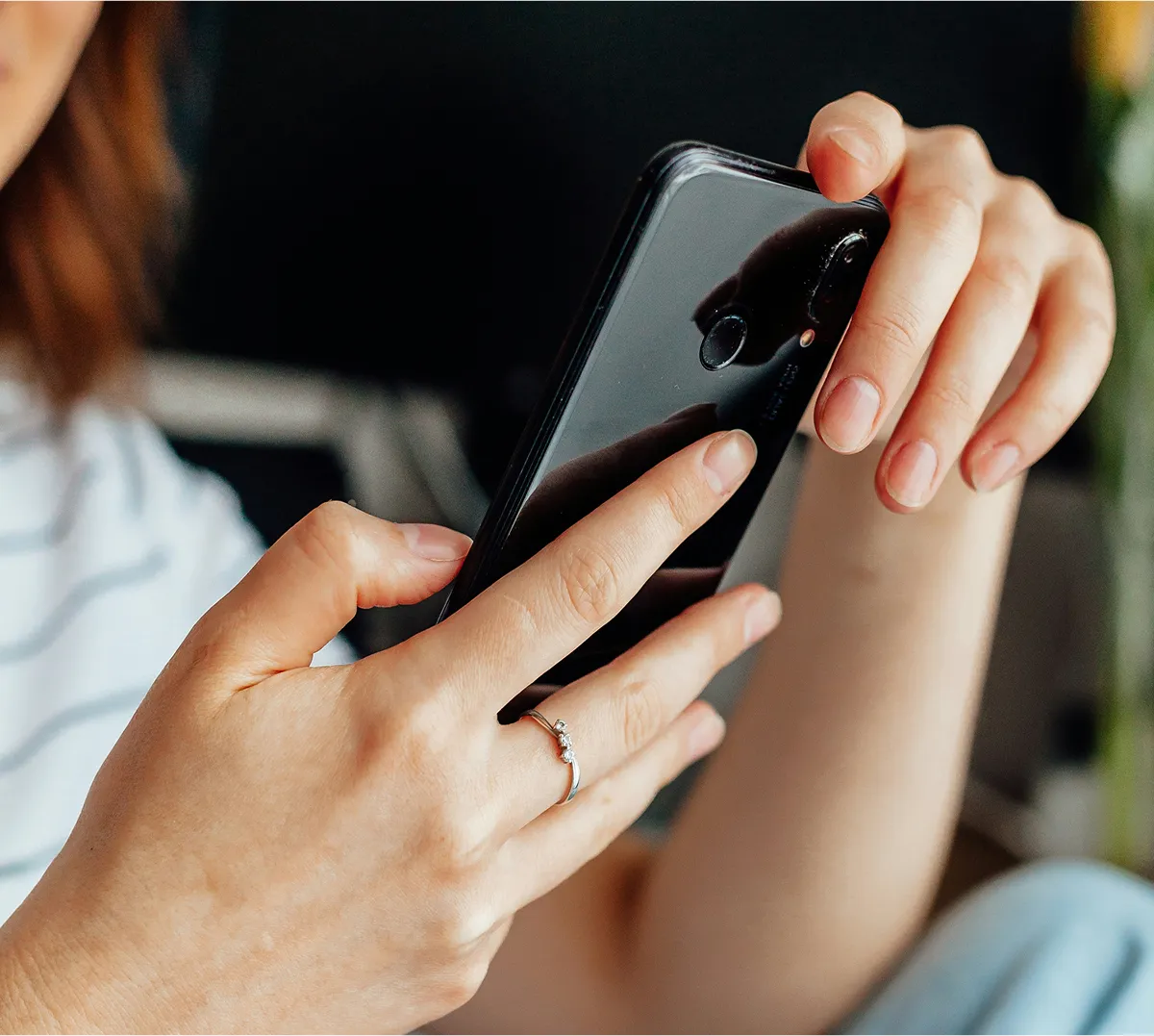 A housekeeper checking her phone