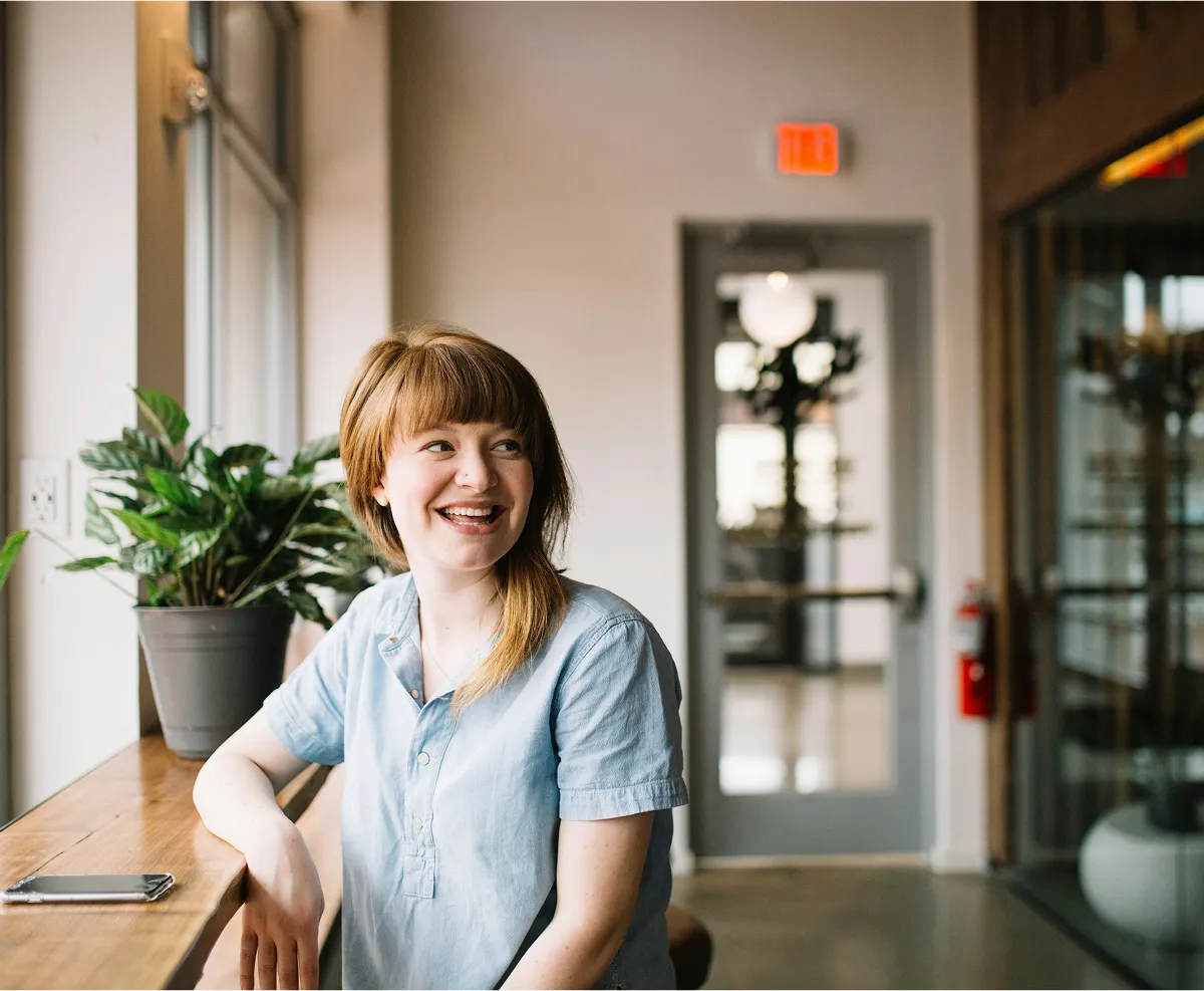 A smiling housekeeper at a kitchen counter