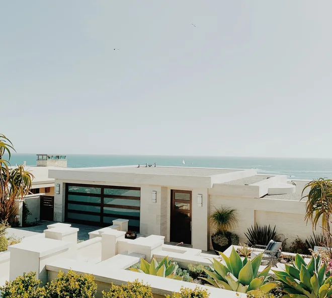 A whitewashed coastal villa above the sea