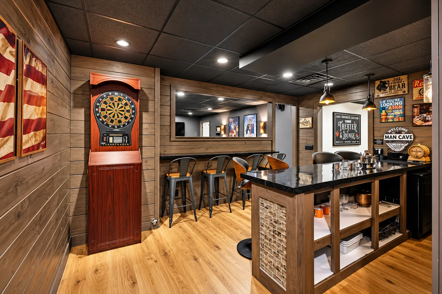 Basement bar area with wood-paneled walls, an electronic dartboard, a counter with bar stools, and a serving island with shelves.