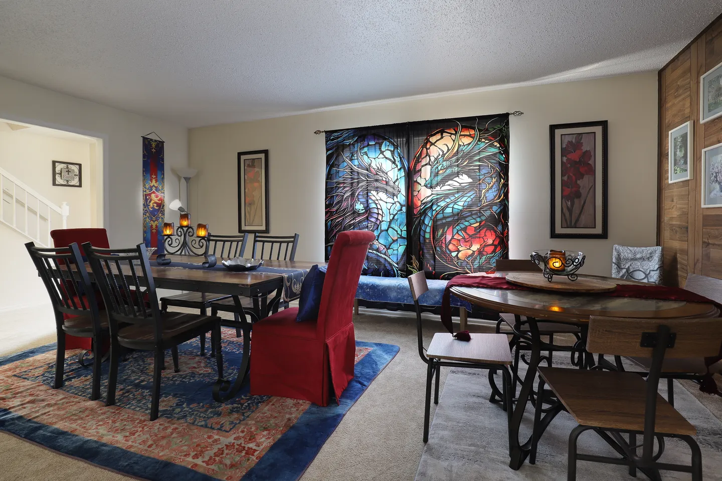 Dining area featuring two dining tables with chairs, patterned rugs on carpeted floors, and curtains printed with a dragon design.
