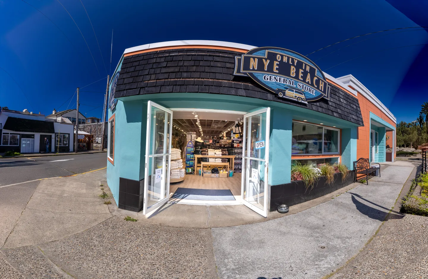 Exterior wide-angle view of the Only in Nye Beach General Store on a paved street corner.