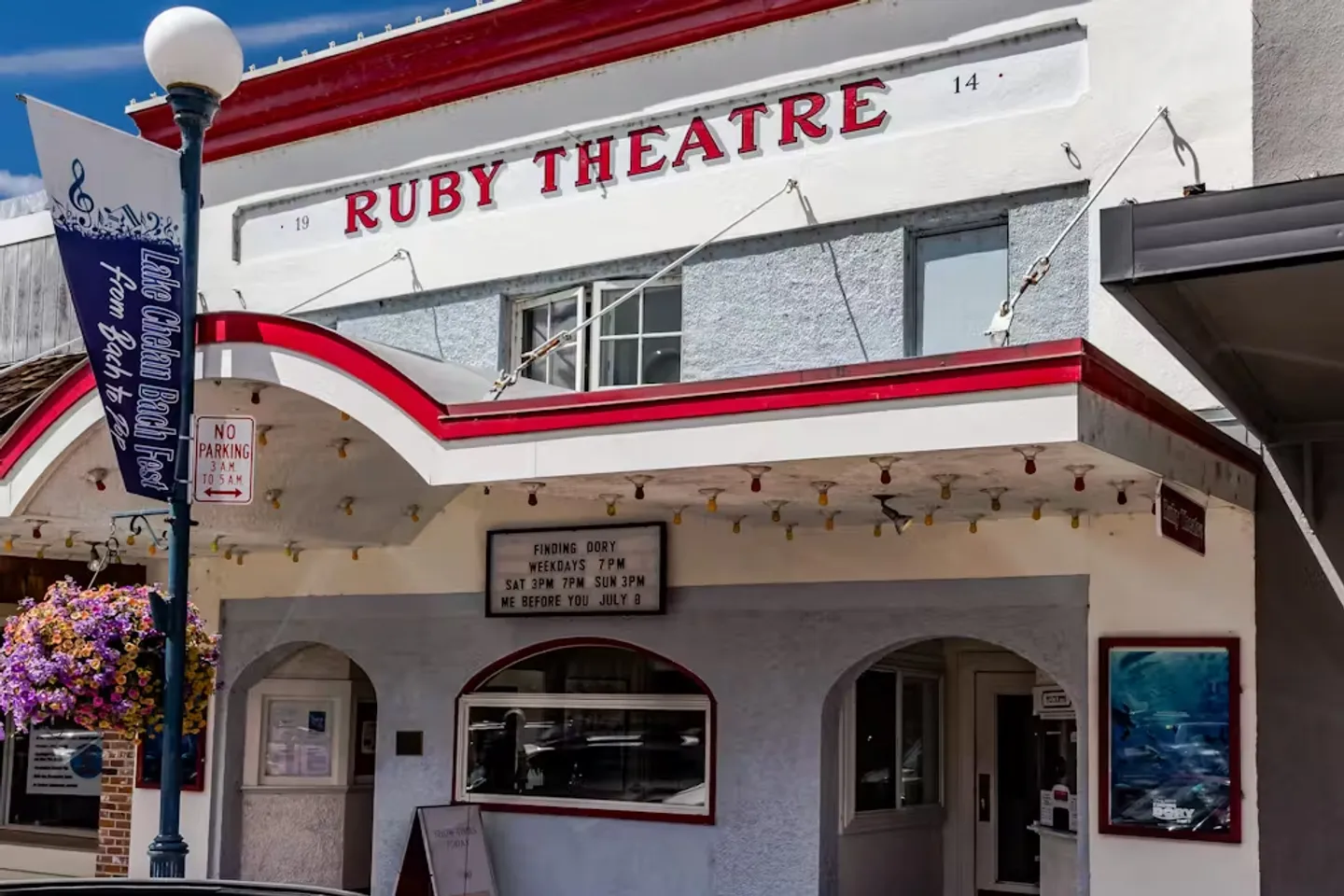 Exterior view of the historic Ruby Theatre building with a marquee and entrance arches under a blue sky.