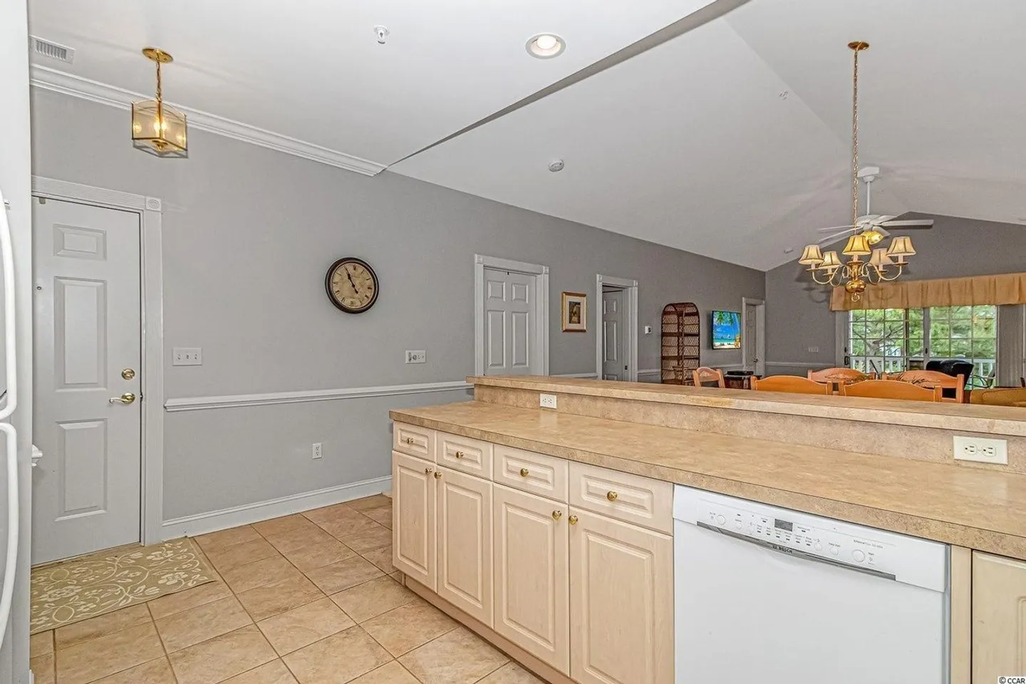Kitchen counter and dishwasher looking into the adjacent dining area and hallway.