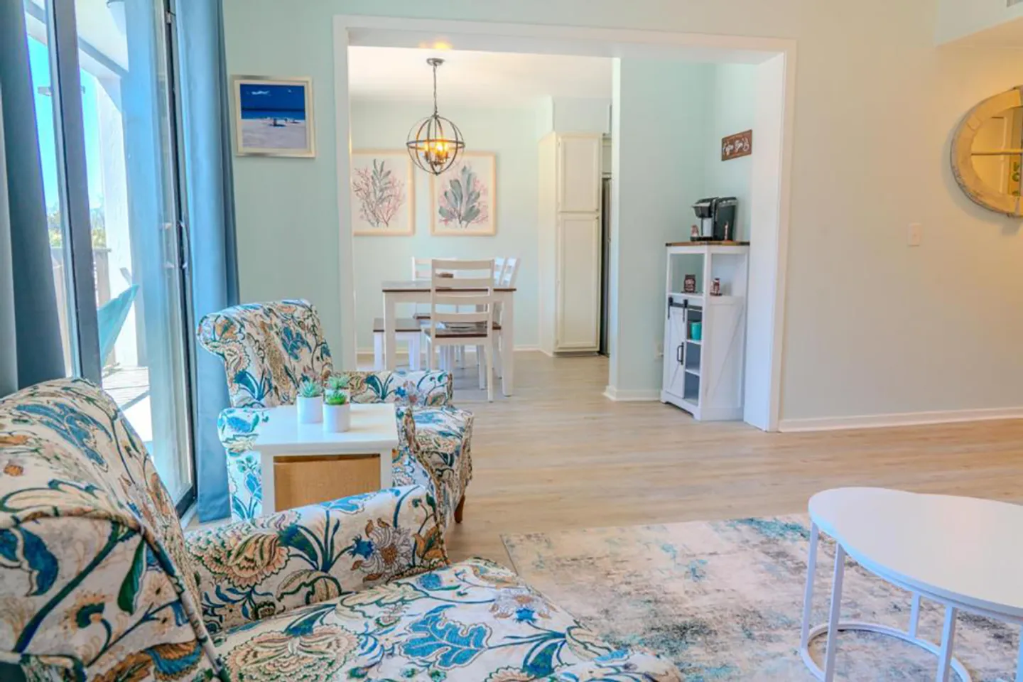 Living room looking through a wide doorway into an adjacent dining area.