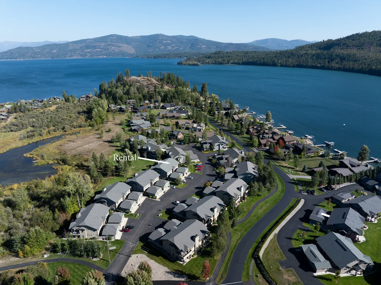 Aerial view of a lakefront residential community with a text marker indicating the rental home.
